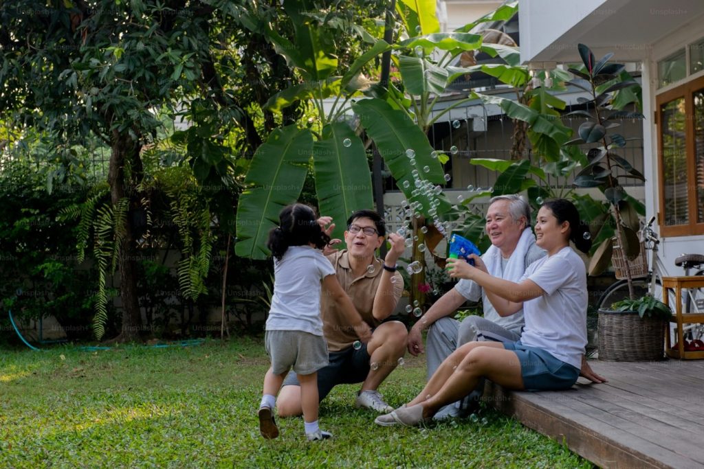 A family gathering in a front yard.