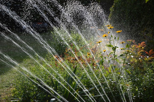 An irrigation system watering a garden.