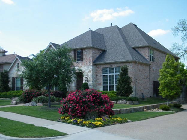 A beautifully landscaped property with flowers and foliage.